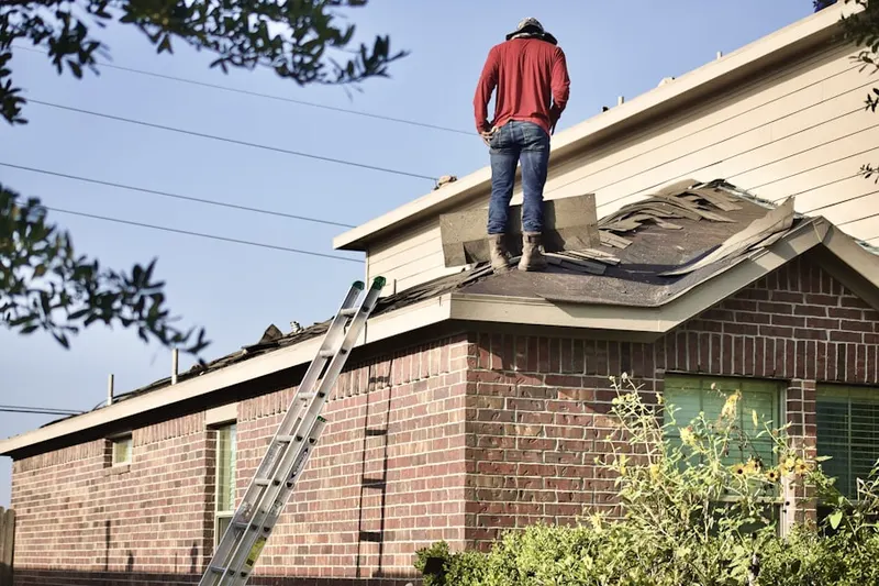 Professional roofer working on a residential roof in Taubitz Farms